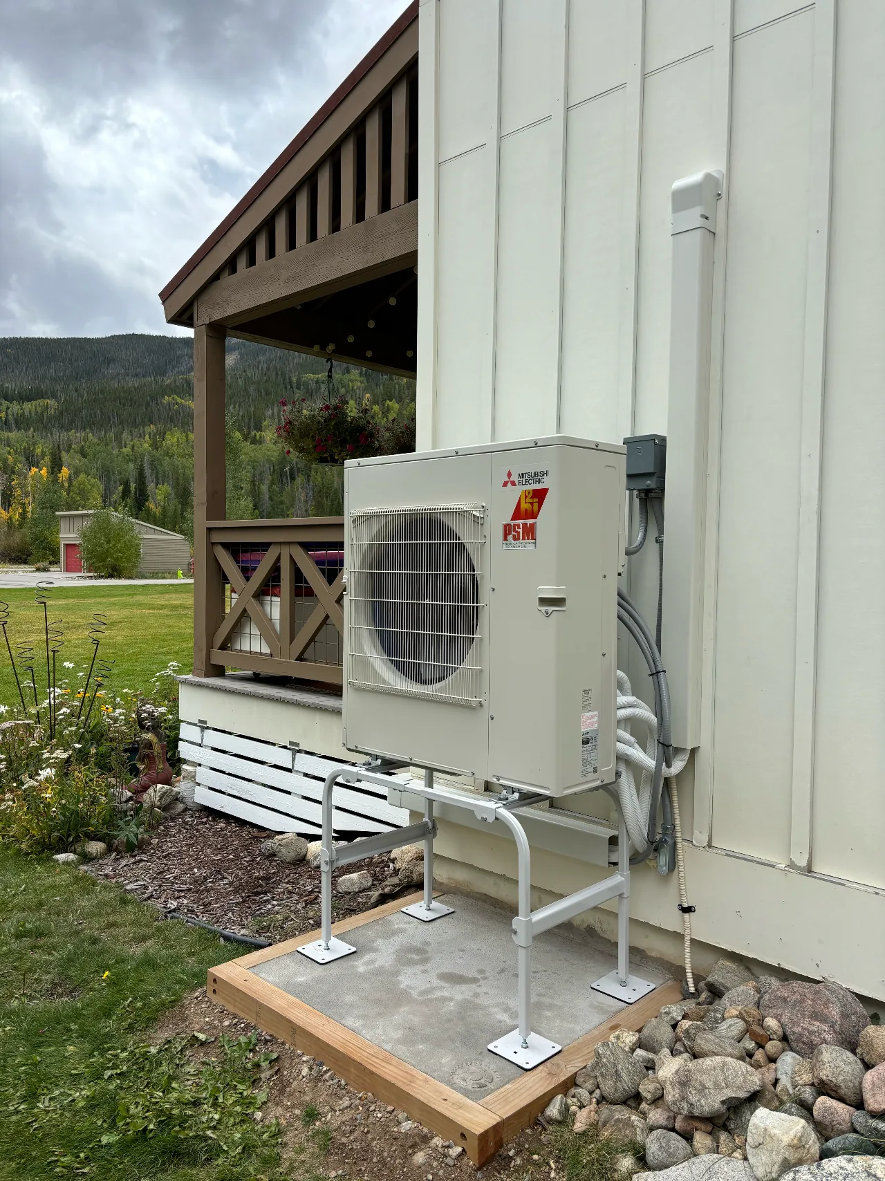 Mitsubishi Electric heat pump on a raised stand